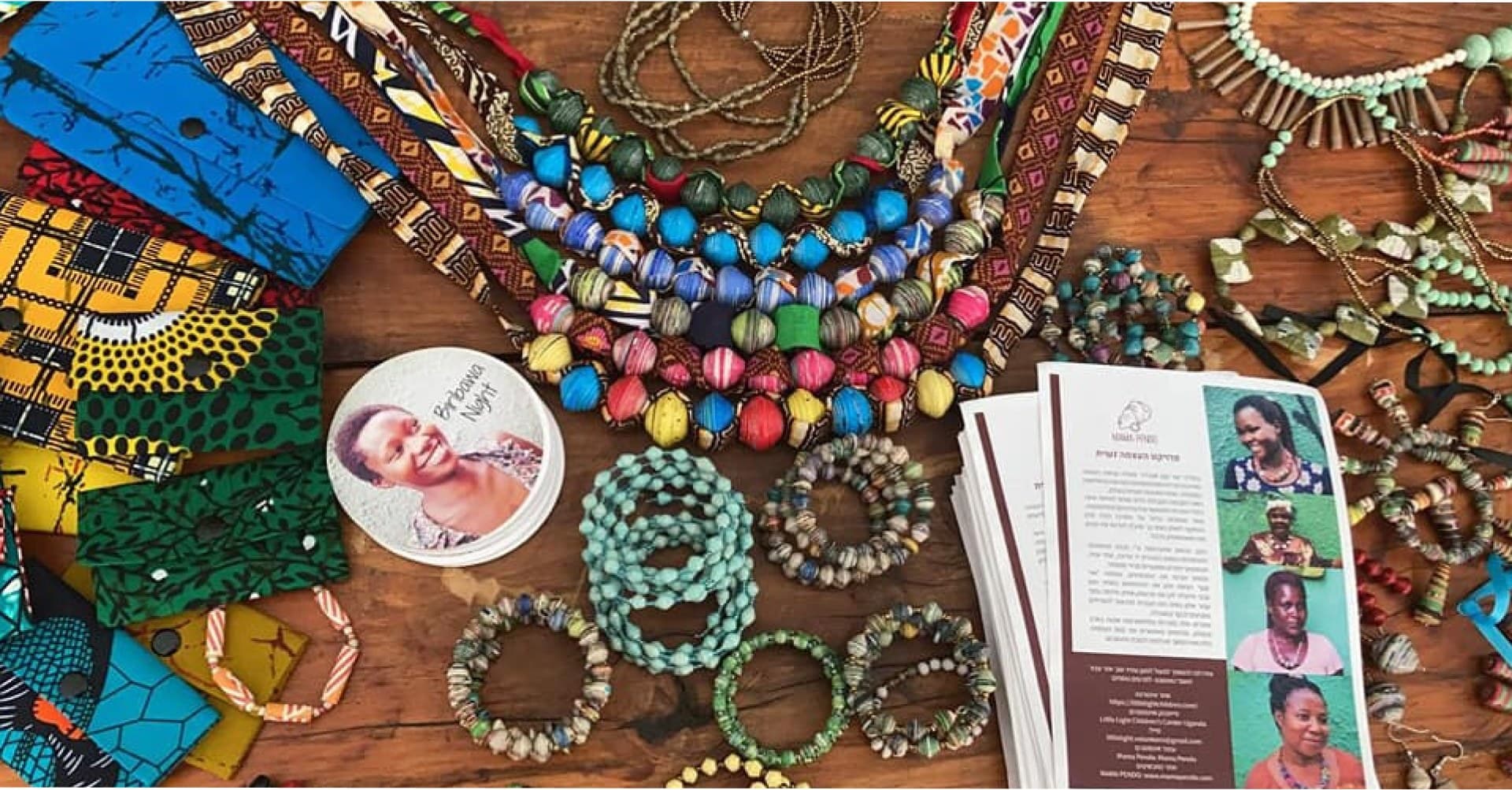 Mama Pendo handmade bead jewelry laid out on a wooden table